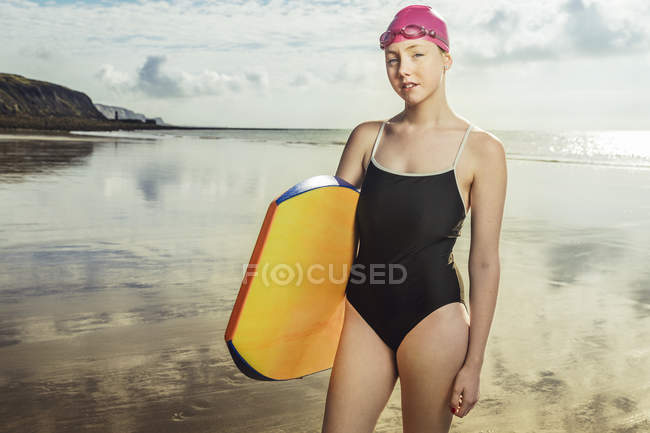 Portrait of young woman in swimming costume on beach — Stock Photo