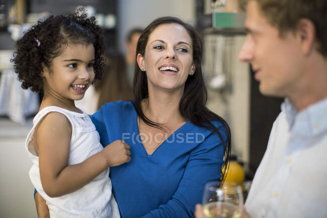 Husband and wife with daughter at party — Stock Photo