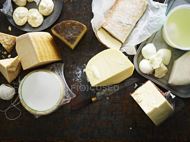 Selection of cheeses on work surface, overhead view — Stock Photo