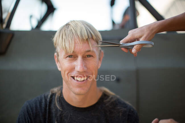 Retrato de jovem tendo corte de cabelo — Fotografia de Stock