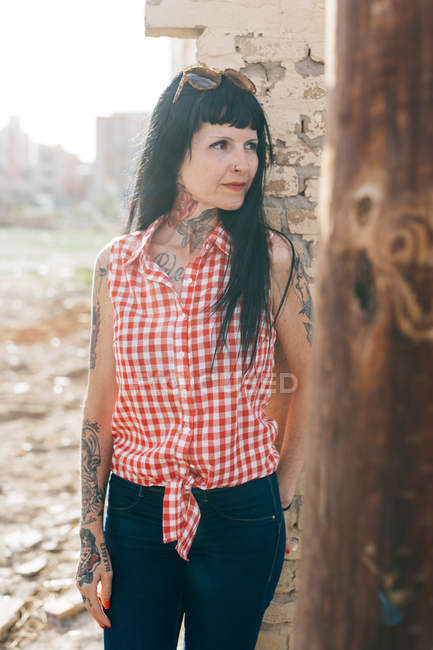 Mature female hipster by demolished building — Stock Photo