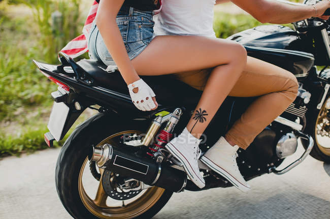 Young couple riding motorcycle on rural road, Krabi, Thailand, waist down — Stock Photo