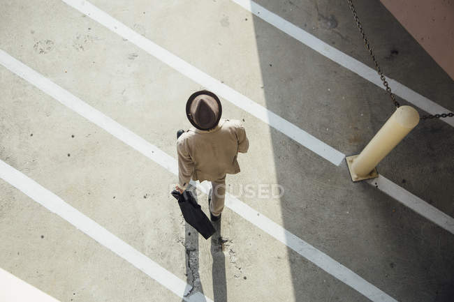 Overhead view of young man walking across road — Stock Photo