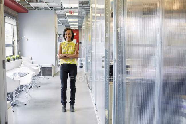 Portrait of young woman in office environment — Stock Photo