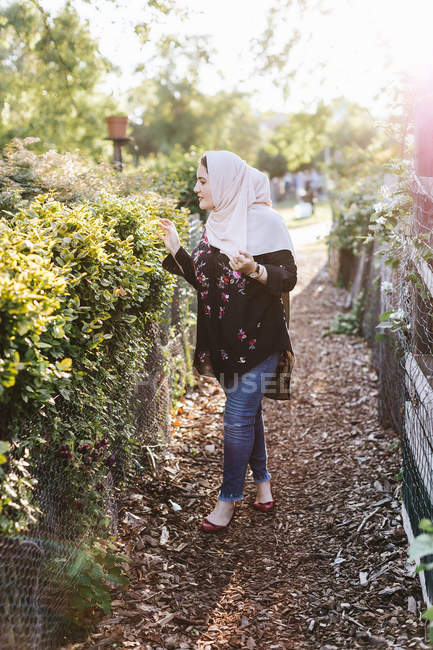 Young woman wearing in hijab near plants — Stock Photo