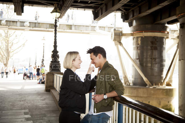 Young woman touching man face and smiling — Stock Photo