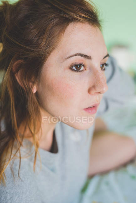 Close up portrait of beautiful young woman gazing — Stock Photo
