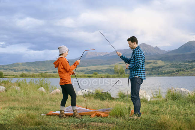 Side view of couple putting up tent, Heeney, Colorado, United States — Stock Photo