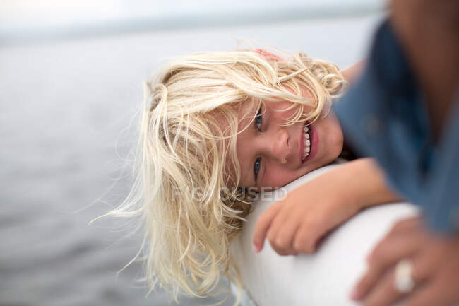 Portrait of young boy near water, smiling — Stock Photo