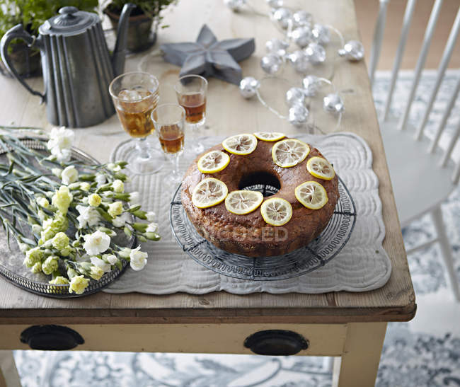 Стіл з bundt торт, квіти та напої — стокове фото