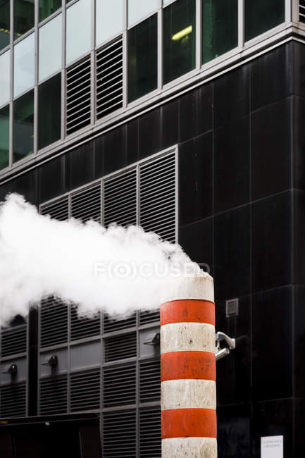 Striped smoke stack and modern office building, Times Square, New York, USA — Stock Photo
