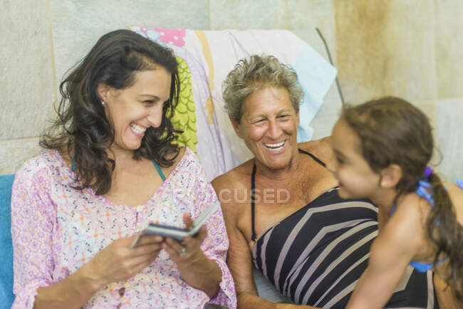 Girl with mother and grandmother on deckchair — Stock Photo