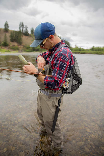 Hombre preparando cebo en el río, Clark Fork, Montana - foto de stock
