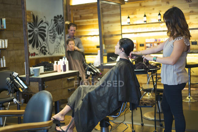 Hairstylists working in salon — Stock Photo