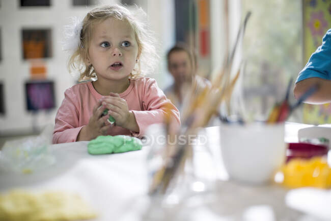 Girl playing with clay — Stock Photo
