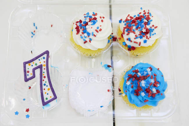 Cakes with number seven candle on table — Stock Photo