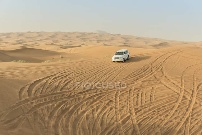 Veículo fora de estrada que desce dunas do deserto, Dubai, Emirados Árabes Unidos — Fotografia de Stock