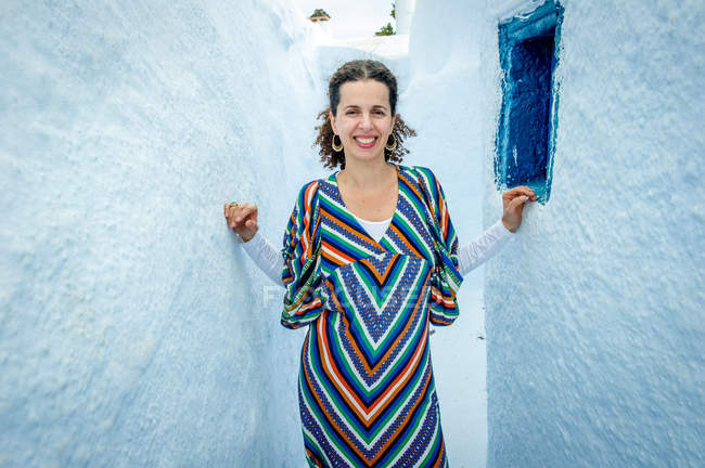 Femme debout dans un étroit espace entre les murs, Santorin, Kikladhes, Grèce — Photo de stock