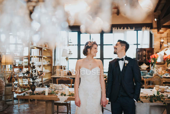 Bride and bridegroom in dining room of wedding reception — Stock Photo