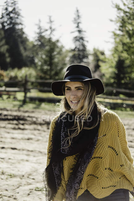 Portrait of woman wearing hat and scarf looking away smiling, Oshawa, Canada, North America — Stock Photo