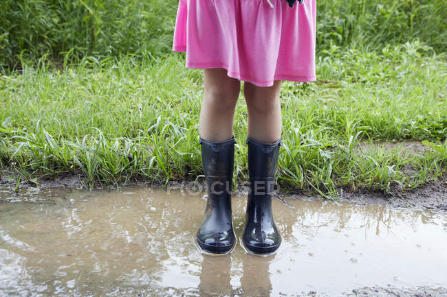 Menina de pé na lama, seção baixa — Fotografia de Stock