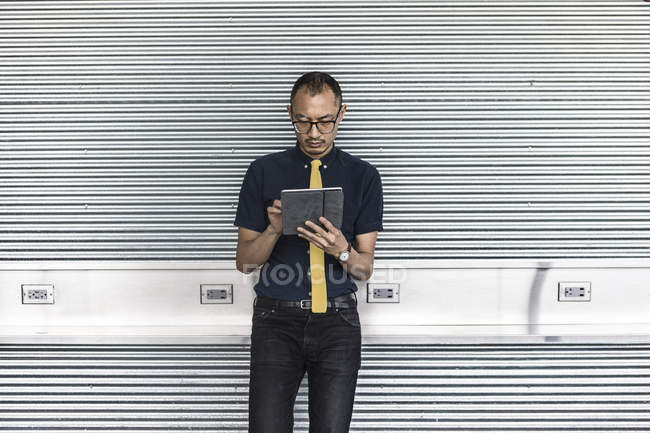 Businessman using touchscreen on digital tablet — Stock Photo