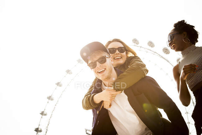 Three friends, fooling around, outdoors, London Eye in background, London, England, UK — Stock Photo