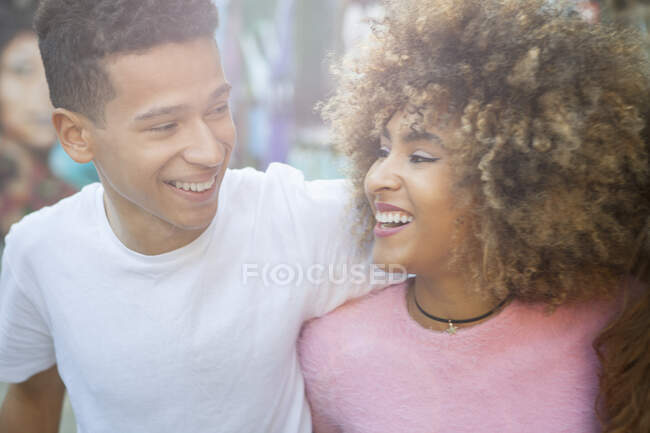 Young couple in street, face to face, laughing — Stock Photo
