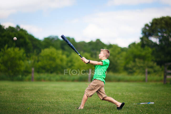 Мальчик играет в бейсбол на поле — стоковое фото