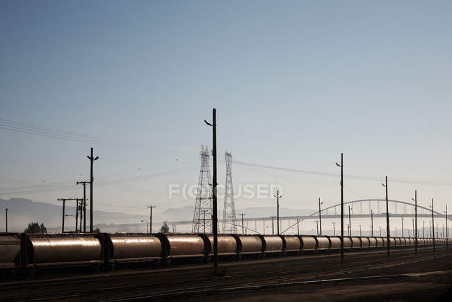 Train tankers and electricity pylons, Canada — Stock Photo