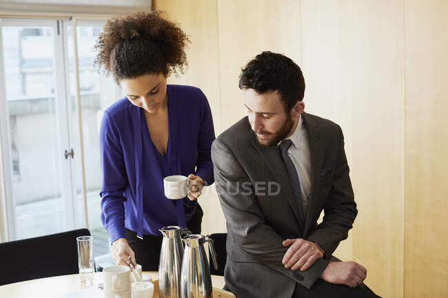 Femme d'affaires et homme prenant une pause café pendant la réunion de bureau — Photo de stock
