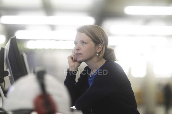 Side view of woman daydreaming in office — Stock Photo