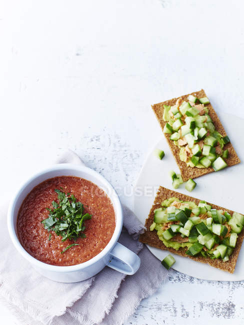 Bowl gazpacho with salmon and rye crackers — Stock Photo