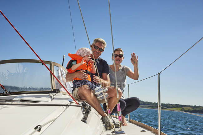 Senior man with daughter and granddaughter on yacht, portrait, Devon, UK — Stock Photo