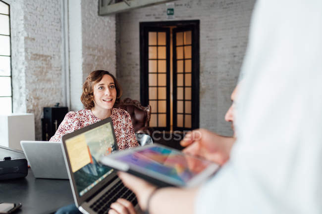 Colleagues using laptops and digital tablet — Stock Photo