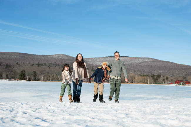 Família andando na neve — Fotografia de Stock