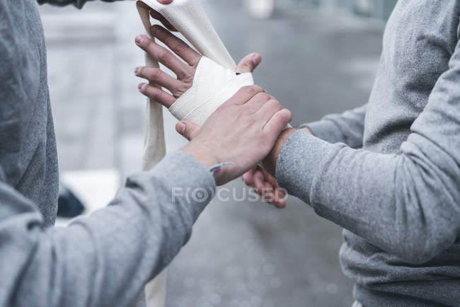 Male bandaging hands with hand wraps — Stock Photo