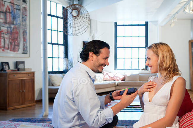 Man surprising wife with gift — Stock Photo