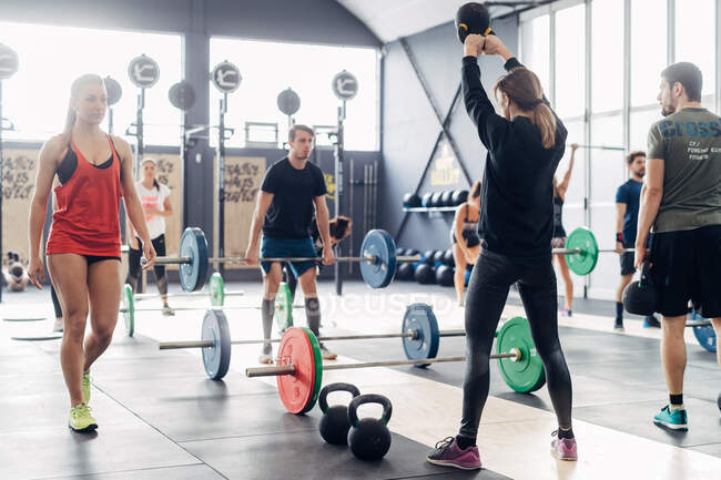 Group of people weightlifting in gym — Stock Photo