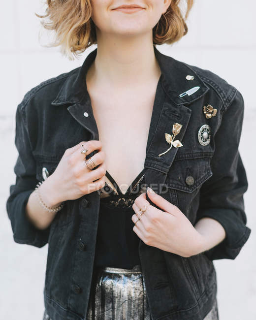 Cropped view of woman wearing denim jacket with pin badges — Stock Photo