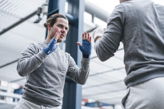 Identical male adult boxers training outdoors — Stock Photo