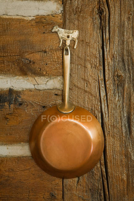 Copper pan hanging up, close up — Stock Photo