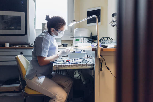 Dentista trabajando en laboratorio - foto de stock