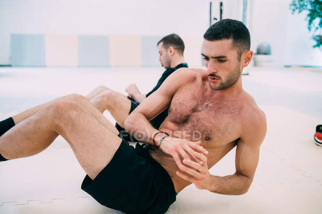 Hombre haciendo ejercicios abdominales - foto de stock