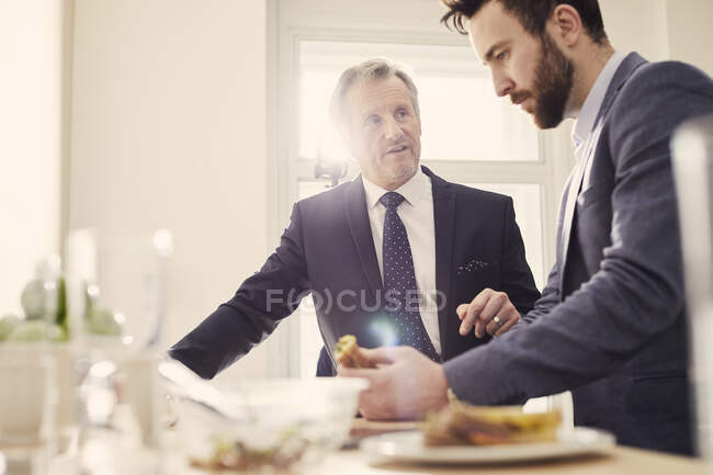 Businessmen meeting over working lunch — Stock Photo