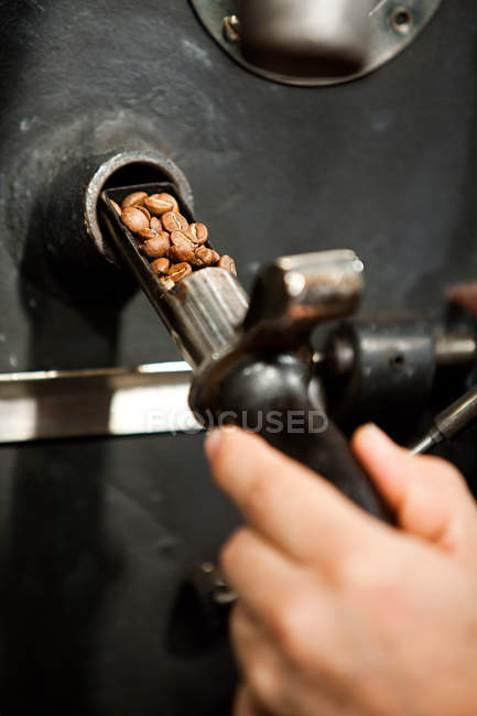 Close up of man using coffee grinder — Stock Photo