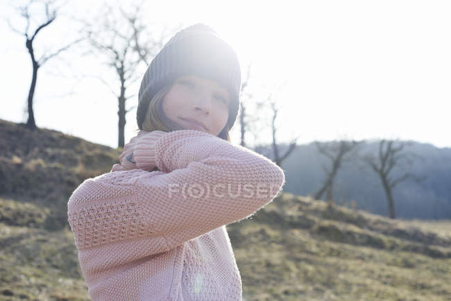 Portrait of woman in knitted hat in field — Stock Photo