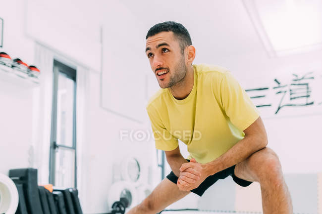 Homem no ginásio fazendo exercícios de alongamento — Fotografia de Stock