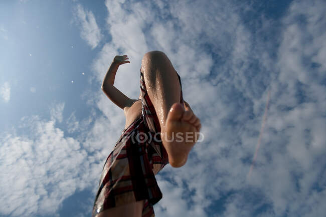 Boy jumping over camera — Stock Photo