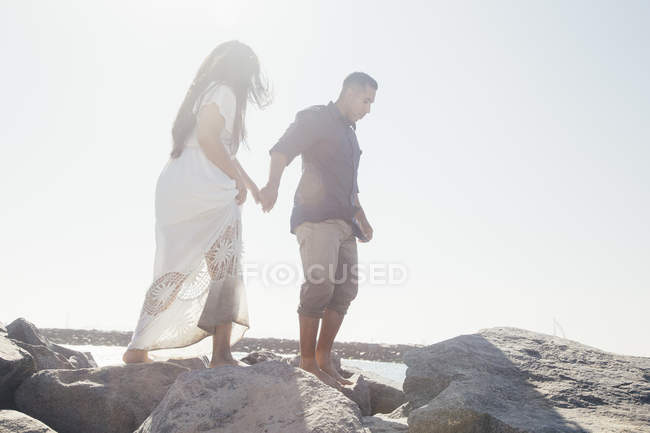 Paar steht auf Küstenfelsen, niedrigen Winkel Blick, Robbenstrand, Kalifornien, Vereinigte Staaten — Stockfoto